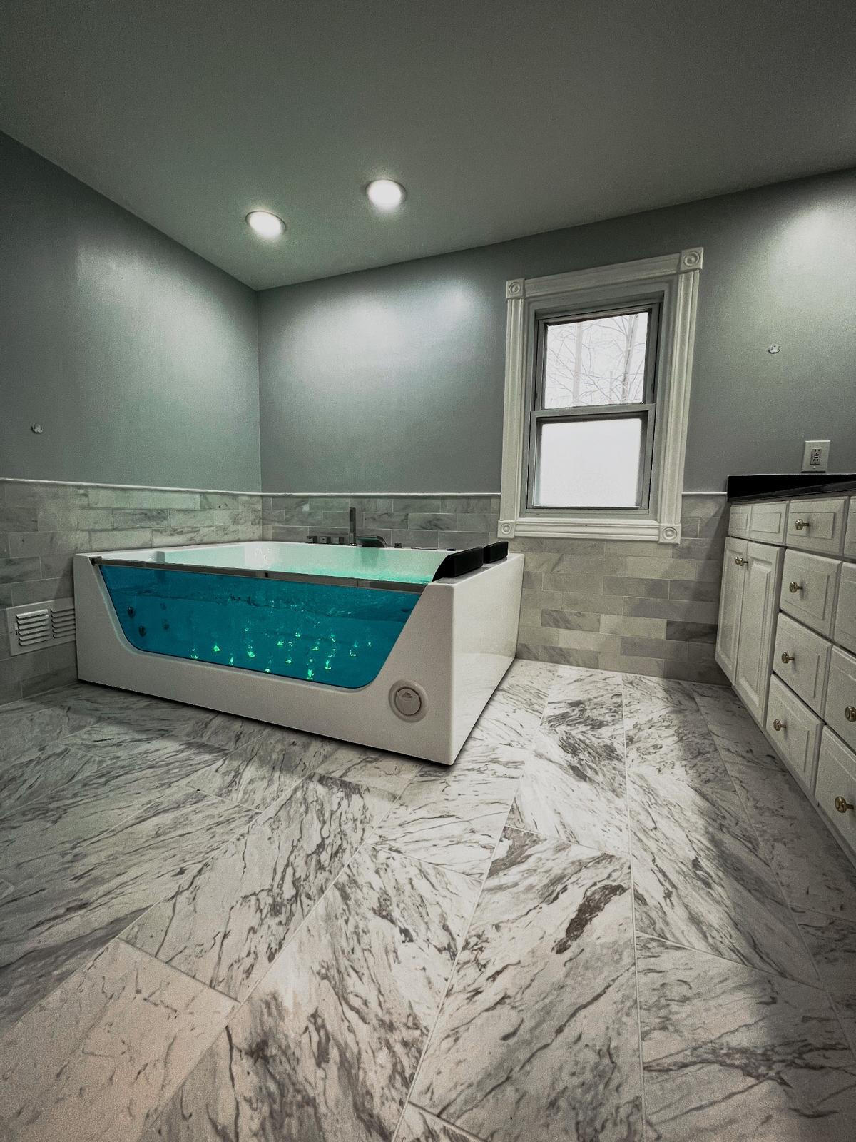 Bathroom Remodeling – Dymond Building Co. Custom bathroom remodel featuring a freestanding tub and tile accent wall by Dymond Building Co. in Royal Oak, MI